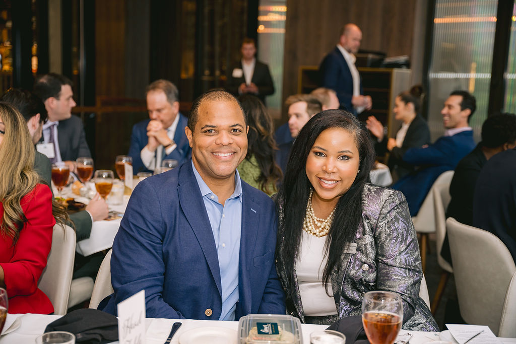 Image of two people sitting at a table at a networking event